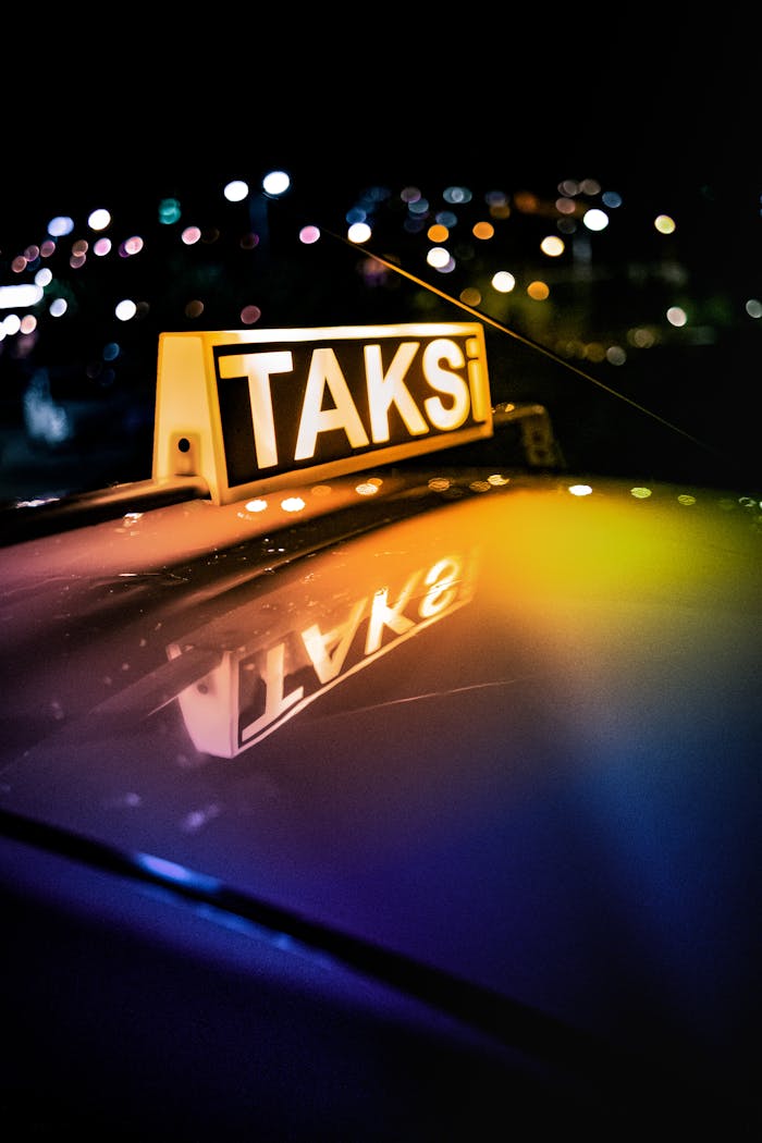 gallery-6 Close-up shot of a Turkish taxi sign with neon lights reflecting at night.