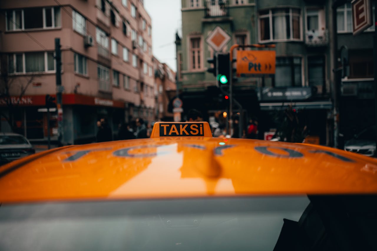 gallery-3 Close-up of a yellow taxi in Istanbul, capturing the vibrant city life and architecture.